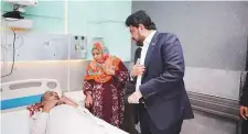  ?? Courtesy Sindh Governor House ?? Sindh Governor Kamran Khan Tessori meets a patient and his attendant at Abbasi Shaheed Hospital in Karachi.