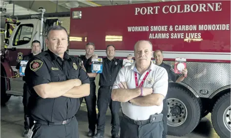  ?? FRANKI IKEMAN/WELLAND TRIBUNE ?? Port Colborne Fire and Emergency Services fire prevention officer Scott Lawson, left, and deputy fire chief Michael Bendia are joined by fire department staff at the fire hall in this file photo.