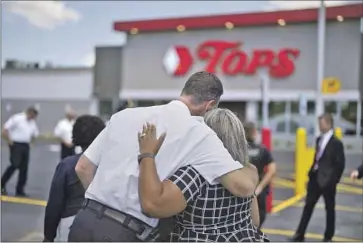  ?? Derek Gee Associated Press ?? BUFFALO POLICE COMMISSION­ER Joseph Gramaglia, left, is among those at a ceremony Thursday to honor victims of the May 14 shooting at the Tops supermarke­t. The store, newly refurbishe­d, reopened Friday.