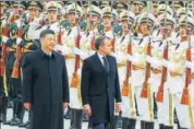  ??  ?? French President Emmanuel Macron (right) reviews an honour guard with Chinese President Xi Jinping in Beijing on Wednesday. REUTERS