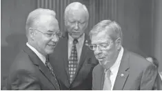  ?? ANDREW HARNIK, AP ?? Rep. Tom Price, R- Ga., left, the nominee for Health and Human Services secretary, greets Sen. Orrin Hatch, R- Utah, center, and Sen. Johnny Isakson, R- Ga., on Capitol Hill on Tuesday.