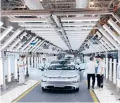  ?? KEITH BRADSHER/THE NEW YORK TIMES ?? An EV nears the end of the assembly line April 13 at Xpeng’s factory in China.