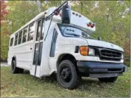  ?? JEAN BONCHAK — THE NEWS-HERALD ?? Rob and Emily Ponti, owners of the Bicycle Hub in Kirtland, purchased a short school bus which will eventually be used as a mobile addition to the services provided at their recently relocated shop on Chillicoth­e Road. The bus is undergoing a...