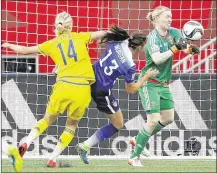  ?? JOHN WOODS / CANADIAN PRESS ?? Sweden goalkeeper Hedvig Lindahl comes up with a save on a header by U.S. player Alex Morgan as Amanda Ilestedt tries to help on defense. Lindahl was named player of the game.