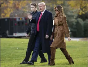  ?? EVAN VUCCI - ASSOCIATED PRESS ?? In this Nov. 26file photo, President Donald, first lady Melania Trump, and Barron Trump, walk to board Marine One on the South Lawn of the White House, in Washington. Melania Trump is quietly forging her way through President Donald Trump’s impeachmen­t.