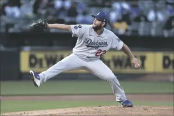  ?? JED JACOBSOHN?AP ?? LOS ANGELES DODGERS PITCHER CLAYTON KERSHAW throws to an Oakland Athletics batter during the first inning of a game in Oakland, Calif. on Tuesday.