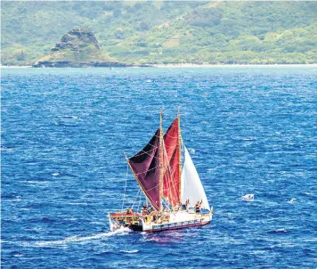  ??  ?? The crew of Hokule’a sail it through Kaneohe Bay in Hawaii, after a world tour that saw them travel for three years and visit 19 countries