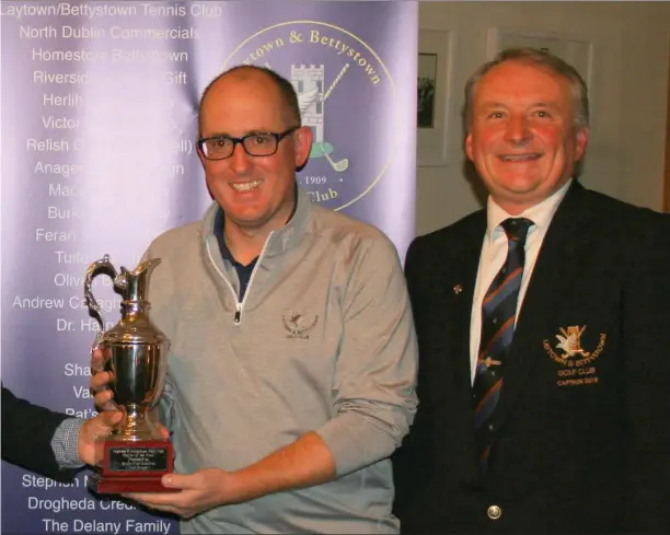  ??  ?? Club Captain Bryan Collins present the Golfer of the Year 2018 trophy to overall winner Dan Hughes.