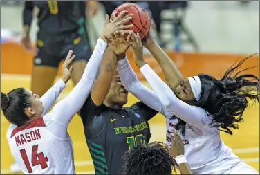  ?? Associated Press ?? Battle for the ball: Wright State forward Shamarre Hale, center, battles for the rebound with Arkansas guard Jailyn Mason (14) and forward Erynn Barnum during the first half of a college basketball game in the first round of the women's NCAA tournament Monday at the Frank Erwin Center in Austin, Texas.