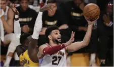  ?? MARK
J. TERRILL THE ASSOCIATED PRESS
FILE PHOTO ?? Denver Nuggets guard Jamal Murray shoots past Lakers guard Dennis Schroder in Game 4 of the NBA’s Western Conference final series Monday night in Los Angeles.