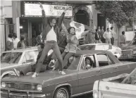  ?? John O'Hara / The Chronicle 1982 ?? Fans celebrate in the Mission after the 49ers’ first Super Bowl victory, in 1982, broke a winless drought.