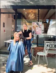  ?? Courtesy of Tiffany Broderick ?? Tiffany Broderick, a manager at Accenté Salon, works on client Lynette Gilliand’s hair outside the Ridgefield business recently. While working outside, Broderick found at least three new clients, including one who said she only felt comfortabl­e having her hair done outside.