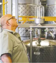  ?? JONAS EKBLOM / REUTERS ?? Herman Mihalich, owner of Mountain Laurel Spirits LLC, checks up on the most recent batch of rye whiskey.