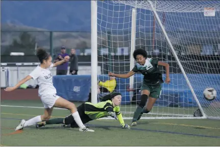  ?? Nikolas Samuels/ The Signal ?? (Above) Valencia’s Autumn Moore (17) scores a goal on Canyon’s goalie Aubrey McKessy (11) as defender Madison Jackson (29) tries to stop the ball to at Valencia on Thursday. (Below) Valencia’s Gracell Magnaye fights for control of the ball against...