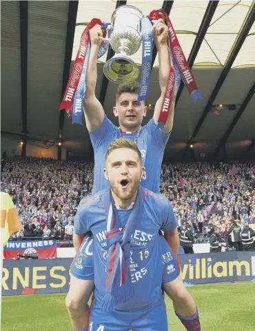  ??  ?? 0 Aaron Doran gets a lift from team-mate Danny Devine as Inverness celebrate their 2015 cup win.