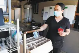  ??  ?? Amacan checks supplies at Amato Home. Nearly 25% of workers in San Franciscoo­wned health care facilities are Filipino American.