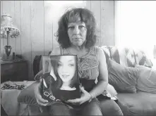  ??  ?? Ann Morrison holds a photo of her daughter, Eva Marie Fullmer, 22, whose body was found in a burning car in Savannah, Ga., a year ago.