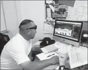  ?? Eric Sondheimer Los Angeles Times ?? BIRMINGHAM COACH Jim Rose watches video in preparatio­n for a playoff game against San Fernando.