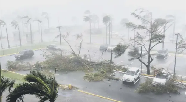  ??  ?? 0 Devastatio­n at Roberto Clemente Coliseum in San Juan, Puerto Rico, as the island is pummelled by winds of up to 155mph after Hurricane Maria came ashore yesterday