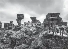  ?? YANG ENUO / FOR CHINA DAILY ?? Unusual rock formations attract tourists at Mount Fanjingsha­n in Guizhou province. The shape is a result of longtime weathering.