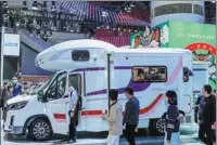  ?? PHOTOS PROVIDED TO CHINA DAILY ?? Top: Vacationer­s enjoy their time at a recreation­al vehicle (RV) campsite outside the city of Yichang, Hubei province, in May 2021. Above: Visitors flock to the booth of SAIC Maxus during an automobile expo in Guangzhou, Guangdong province, in November.