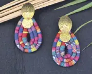  ??  ?? Fabric earrings made of Mindanao woven fabric with deep gold pleated metal.