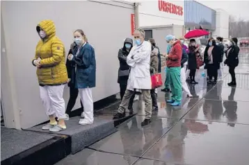  ?? FRANCISCO SECO/AP ?? Health care workers wait in line for the Pfizer-BioNTtech vaccine Wednesday at the MontLegia CHC hospital in Liege, Belgium. The 27-nation EU is coming under sharp criticism for the slow rollout of its vaccinatio­n campaign.