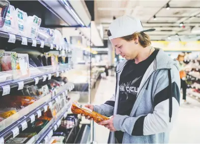  ?? JUHO KUVA / THE NEW YORK TIMES ?? Shoppers can choose from a variety of marked-down food items at the S-market chain in Finland. Prices that are already reduced by 30 per cent are slashed to 60 per cent off at 9 p.m. as part of a campaign to reduce food waste.