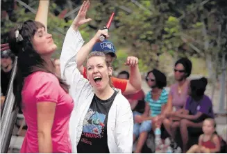  ??  ?? JIM WEBER/THE COMMERCIAL APPEAL Singers Maria Lindsey (left) and Christine Amon sing for a young crowd in the playground at Shelby Farms during a performanc­e Monday of the original mini-opera “The Playground King” as part of Opera Memphis’ 30 Days of...