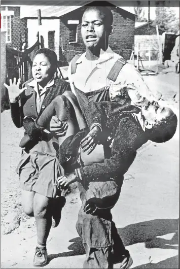  ?? Picture: SAM NZIMA/AFP PHOTO ?? DEFINING IMAGE: Mbuyisa Makhubu carries Hector Pieterson, one of the first children to be shot in the 1976 Soweto uprising, to Sam Nzima’s car. With them is Hector’s sister Antoinette