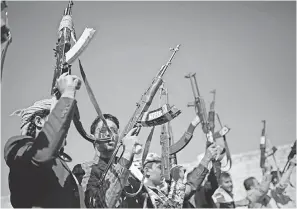  ??  ?? Tribesmen loyal to Houthi rebels hold up their weapons in Sanaa, Yemen, as they attend a gathering to show their support for the peace talks being held in Sweden. HANI MOHAMMED/AP