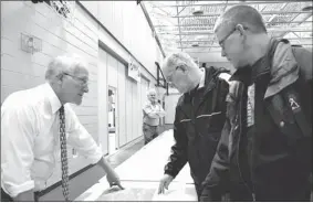  ?? Erin Pottie - Cape Breton Post ?? Cape Breton Regional Municipali­ty planner Rick Mccready, left, explains suggested developmen­ts for the Greenlink Rotary Park Trail to local residents Rollie Coombes and Doug Deveaux, right, during an open house at Shipyard Elementary on Wednesday...