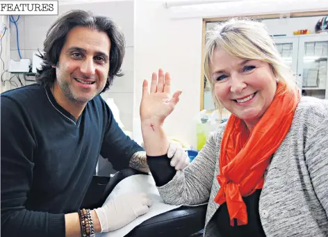  ??  ?? Fern in Jerusalem, right, and showing the cross she had inked on her wrist in a 500-year-old tattoo parlour, left