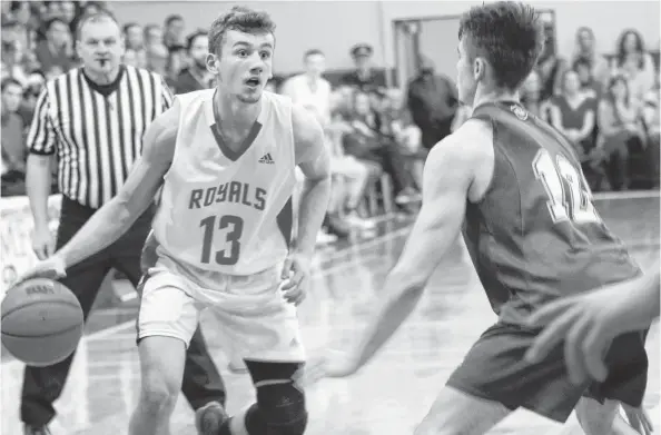  ?? ERIN POTTIE/CAPE BRETON POST ?? Riverview Royals player Josh Crocker, left, looks to take a shot over a player from Halifax Grammar during the New Waterford Coal Bowl Classic championsh­ip final on Saturday. The Gryphons defeated the Royals, 89-66.