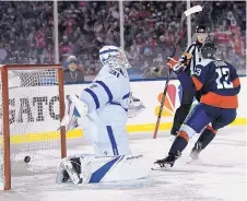  ?? NICK WASS/ASSOCIATED PRESS ?? Washington’s Jakub Vrana, right, celebrates after scoring against Toronto goalie Frederik Andersen during the second period of their game played outdoors at the Naval Academy on Saturday night.