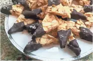  ?? AMY DEWALL DADMUN ?? These Chocolate-Dipped Florentine Shortbread­s are worth all the effort it takes to make them.