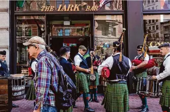  ?? Photos by Brontë Wittpenn/The Chronicle ?? Members of the Irish Pipers Band of San Francisco prepare to perform during a St. Patrick’s Day celebratio­n on Sunday at the Lark Bar on Market Street.