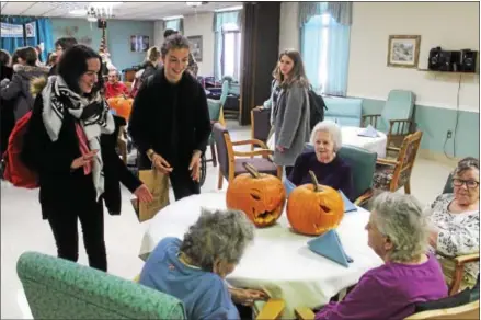  ?? PHOTO PROVIDED ?? French students visiting Ballston Spa High School donate pumpkins to the Saratoga Center Rehab & Skilled Nursing Facility.