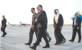  ?? AP PHOTO/JACQUELYN MARTIN ?? Secretary of State Mike Pompeo, center, walks with U.S. Charge d’Affaires Steve Bondy, left, and United Arab Emirates Minister of State Ahmed al-Sayegh, right, as Pompeo arrives in Abu Dhabi on Monday.