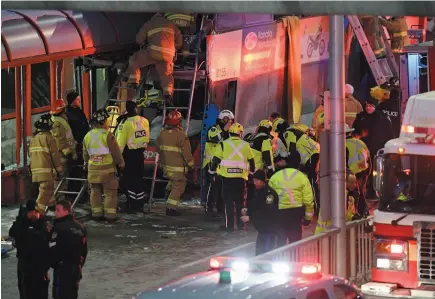  ?? CP PHOTO ?? Police and first responders work at the scene where a double-decker city bus struck a transit shelter in Ottawa on Friday.