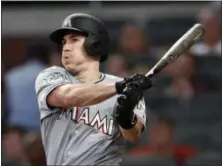  ?? ASSOCIATED PRESS FILE ?? J.T. Realmuto follows through on a double against the Braves last season. The Phillies added the All-Star catcher in a trade that sent cathcer Jorge Alfaro and pitching prospects Sixto Sanchez and Will Stewart to the Miami Marlins Thursday.