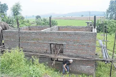  ?? PHOTO: THOMSON REUTERS FOUNDATION ?? Practical skills . . . Kanchhi Rai cleans up the grass around the home she and her husband built recently in the village of Raigaun, Nepal.