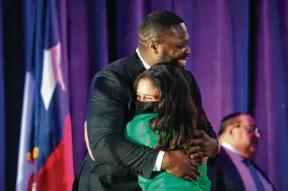  ?? Photos by Mark Mulligan / Staff photograph­er ?? A Worthing student hugs rapper 50 Cent, whose real name is Curtis Jackson, during the induction ceremony Monday for the G-Unity Business Lab at Wheatley High School. The lab will offer MBA-style business classes to students.