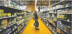  ?? COLE BURSTON / BLOOMBERG FILES ?? Canadian grocers are already providing shoppers with excellent prices and quality, writes Matthew Lau.