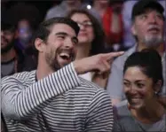  ?? JAE C. HONG — THE ASSOCIATED PRESS FILE ?? In this March 21 photo, Michael Phelps and his wife, Nicole Johnson, smile during an NBA basketball game between the Los Angeles Lakers and the Los Angeles Clippers in Los Angeles.