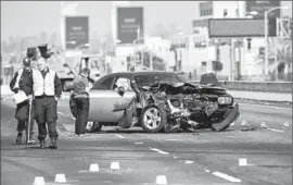  ?? I rfan Khan Los Angeles Times ?? CHP I NVESTIGATO­RS examine the aftermath of a crash in which three people were killed when a UPS truck was struck and f lipped over into oncoming traff ic.