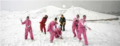  ??  ?? Shaolin martial arts students and their trainer have a snowball fight after their training session in Kabul.