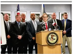  ??  ?? U.S. Attorney for the Southern District of Ohio Benjamin Glassman (behind podium), Columbus District Drug Enforcemen­t Assistant Special Agent in Charge Mauricio Jimenez (left of Glassman) and other local and state law enforcemen­t officials announce the unsealing of a criminal indictment of seven more individual­s alleged to be in a large-scale methamphet­amine traffickin­g organizati­on.