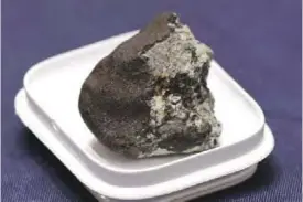  ??  ?? WASHINGTON: This file photo shows a piece of the Chelyabins­k meteorite on display before a hearing of the House Administra­tion Committee in the Longworth House Office Building on Capitol Hill in Washington, DC.—AFP