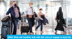  ?? — AFP ?? DOHA: Mask-clad travellers walk with their carry-on luggage to board the first Qatar Airways flight bound for Cairo after the resumption of flights between Qatar and Egypt at Hamad Internatio­nal Airport yesterday.